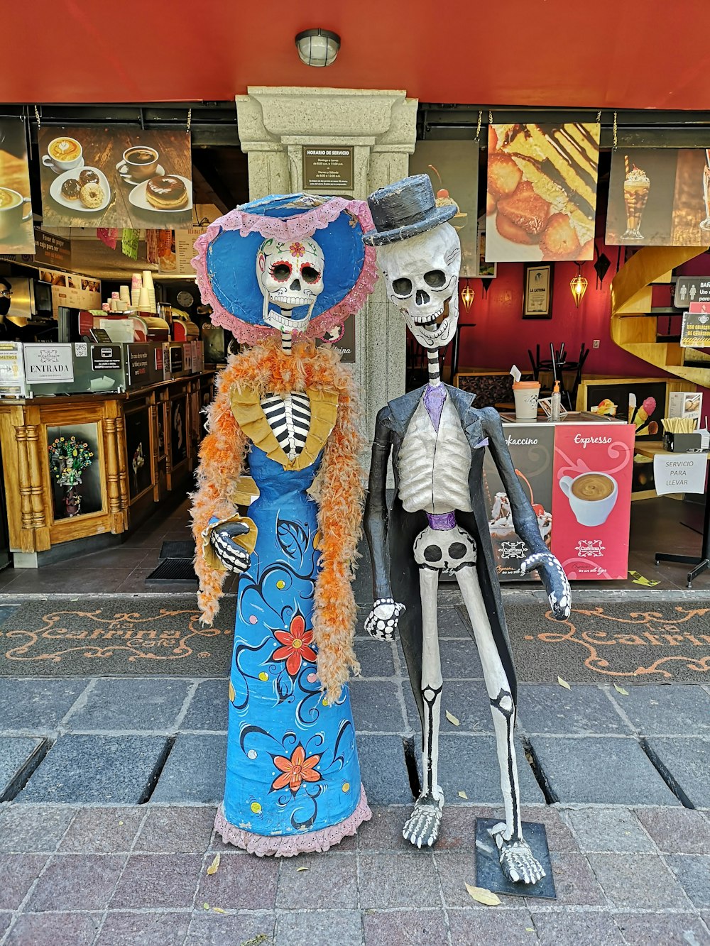 person in blue and white floral kimono standing on sidewalk during daytime