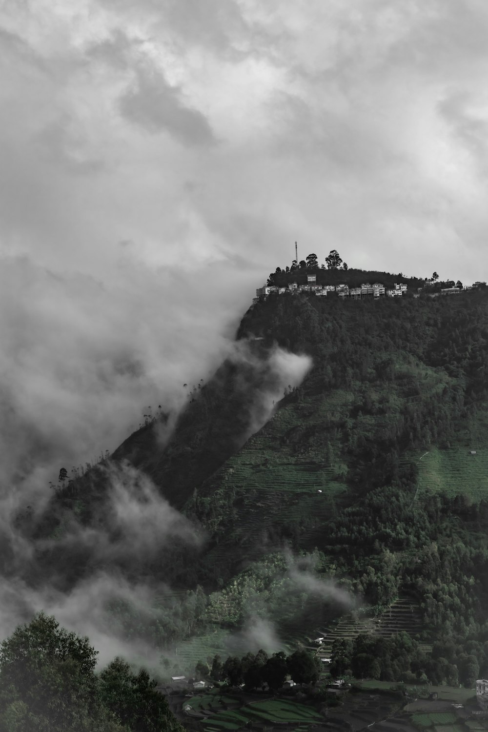 green grass covered mountain under cloudy sky during daytime