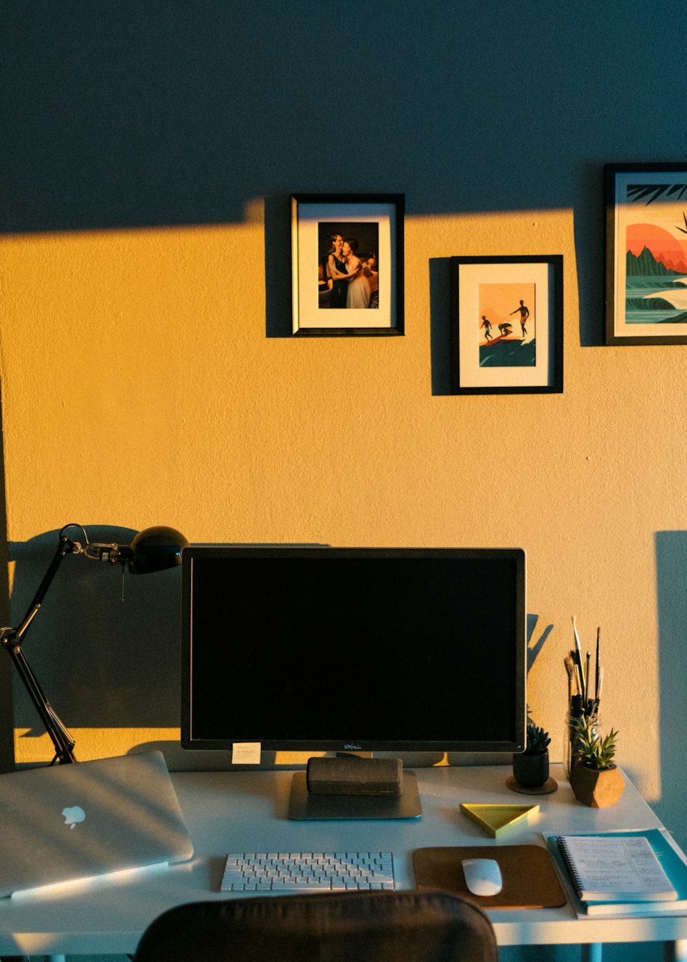 black flat screen computer monitor on brown wooden desk