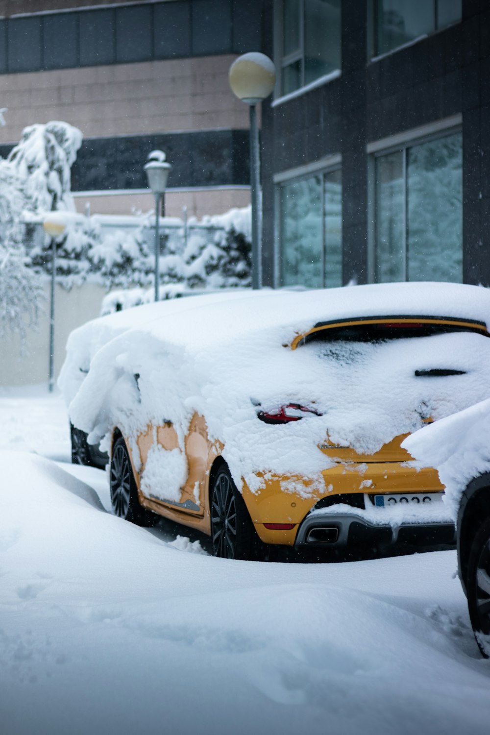 yellow car covered with snow