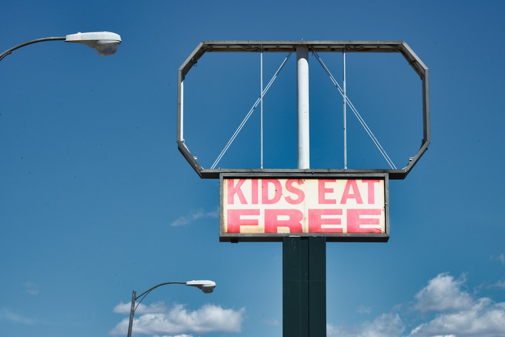 a sign that says kids eat free on it