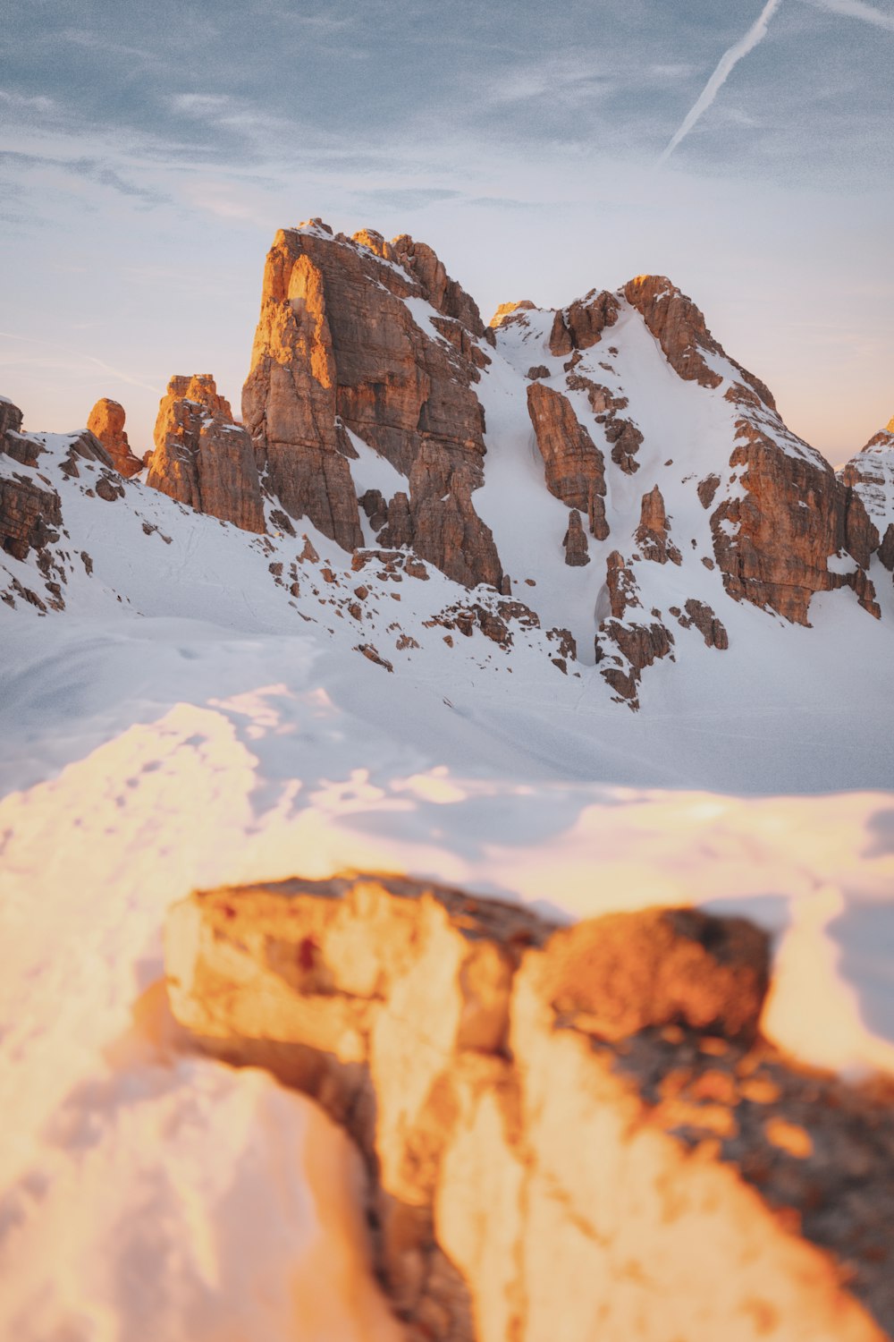 brown rocky mountain covered with snow