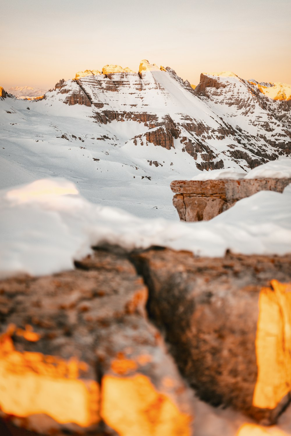 brown rocky mountain covered with snow