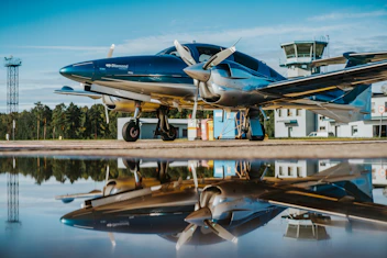 blue and white airplane on brown wooden dock during daytime