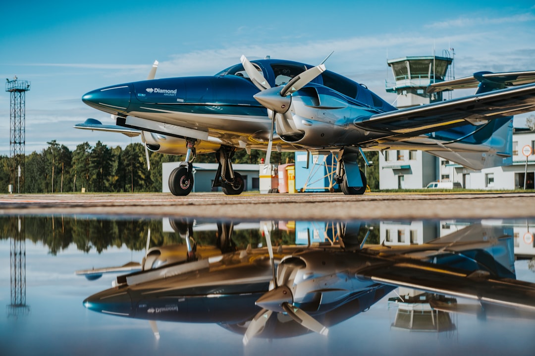 blue and white airplane on brown wooden dock during daytime