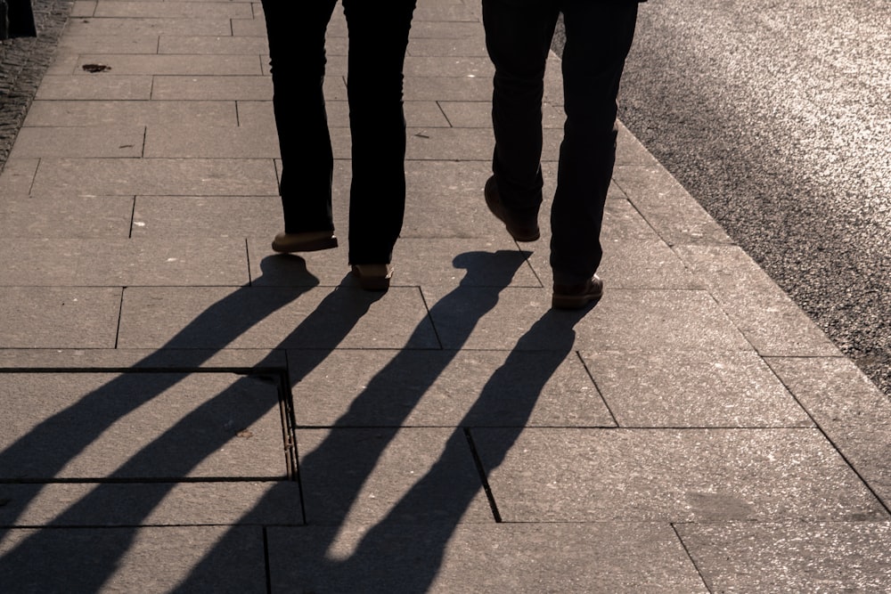 2 person standing on gray concrete pavement