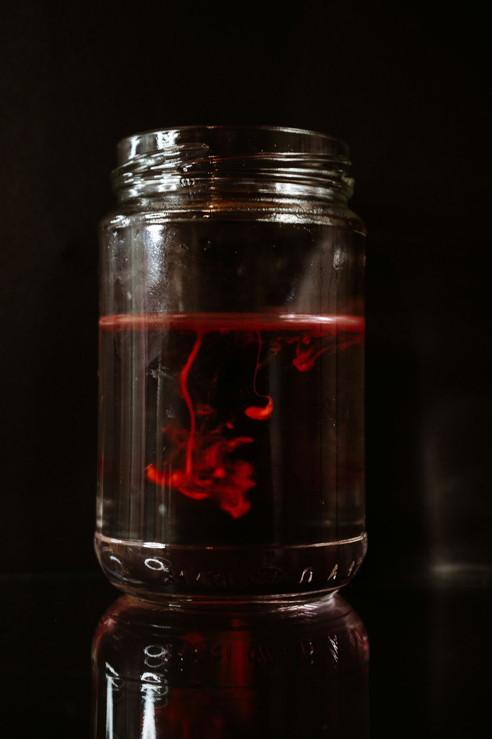 clear glass jar with red liquid