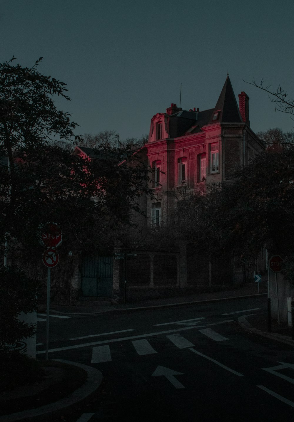 red and white concrete building near green trees during daytime