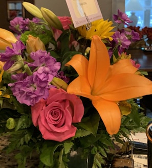 A vibrant bouquet of flowers with a QR code tag.