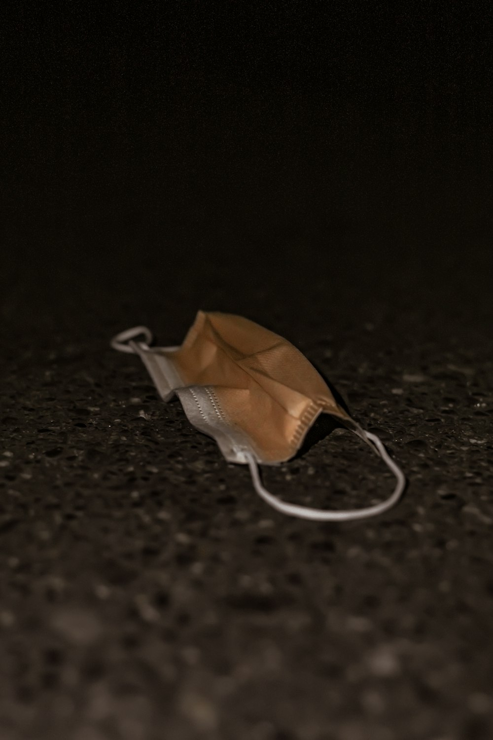 brown umbrella on black sand