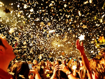 people raising their hands during night time