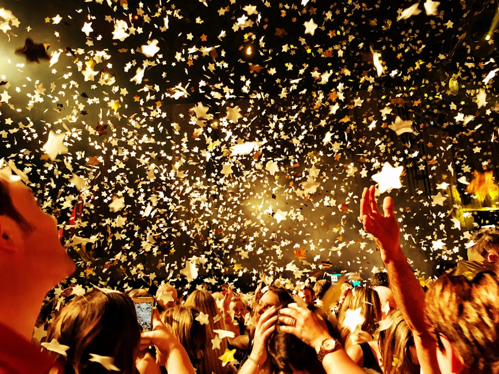 people raising their hands during night time