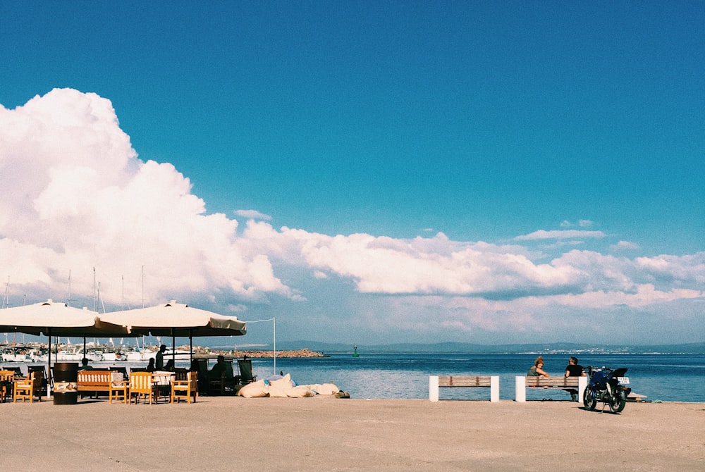 white and brown wooden beach lounge chairs on beach during daytime