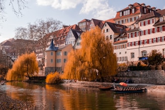 white and brown concrete building beside river during daytime