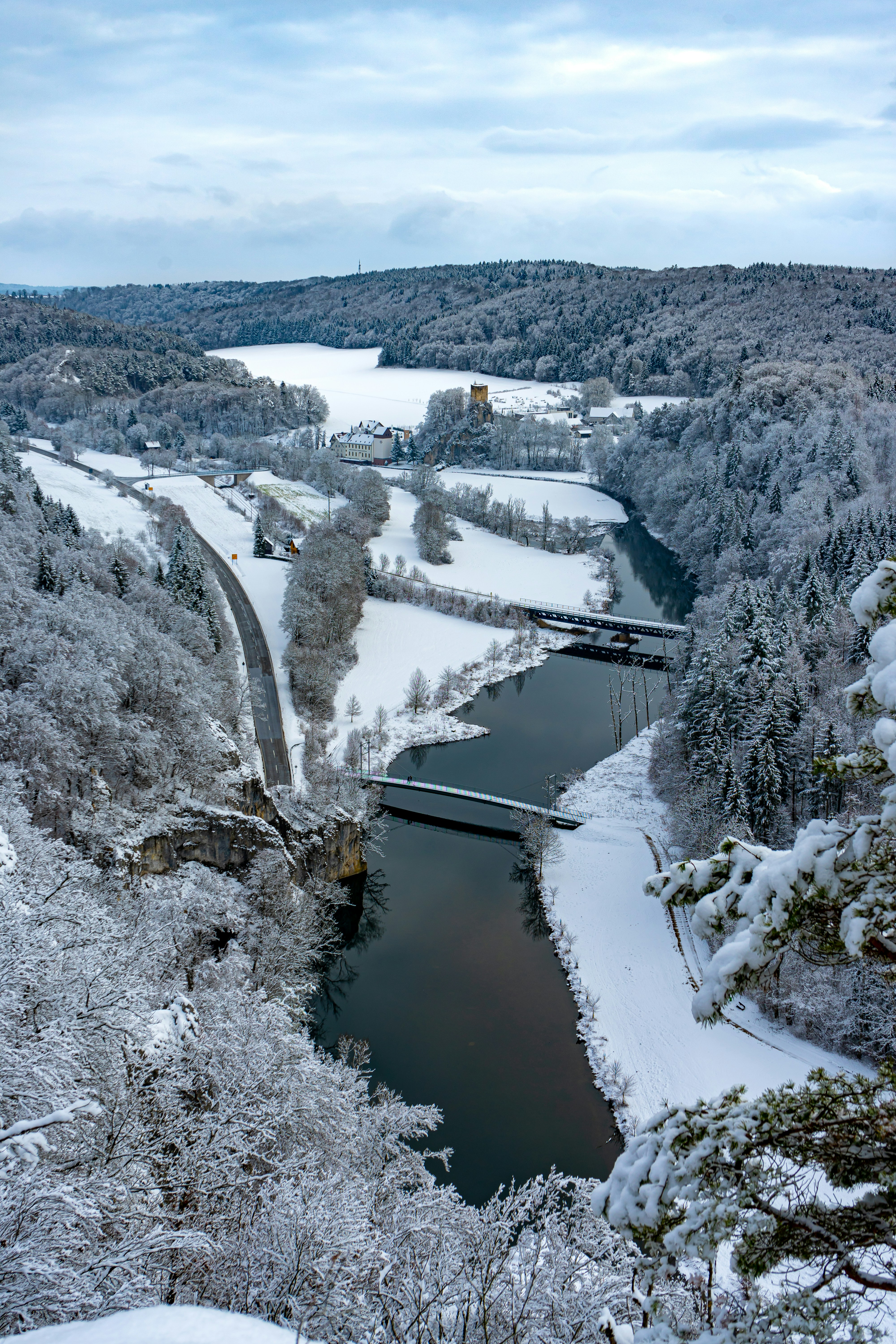 river between snow covered trees during daytime