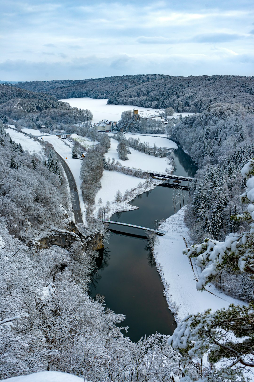 river between snow covered trees during daytime