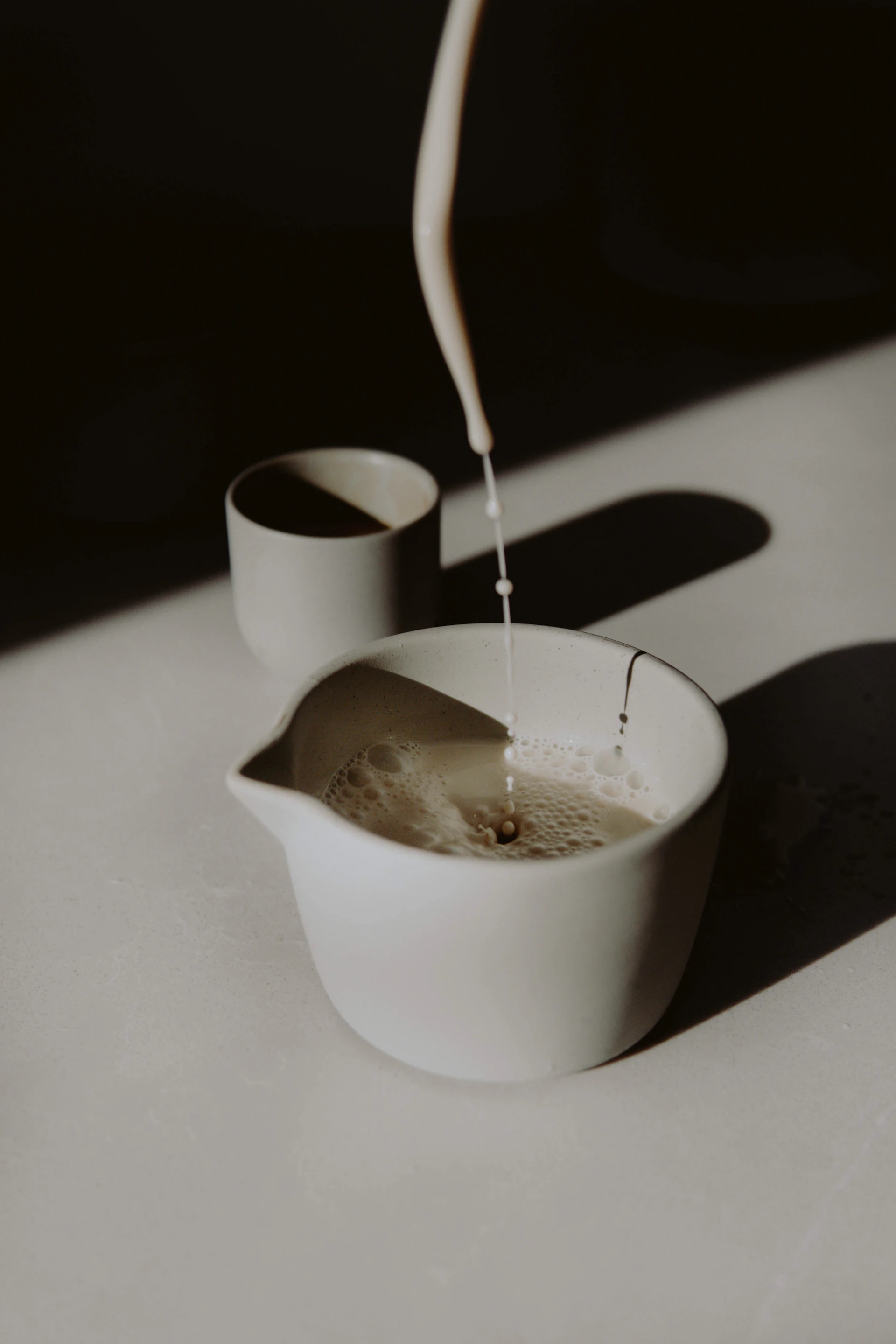 white ceramic cup with silver spoon