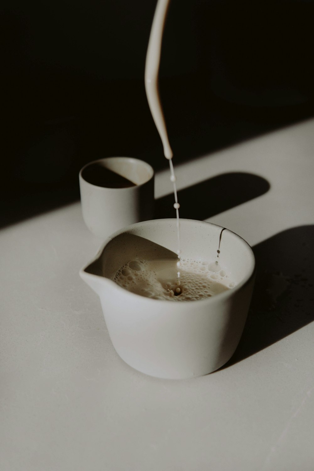 white ceramic cup with silver spoon