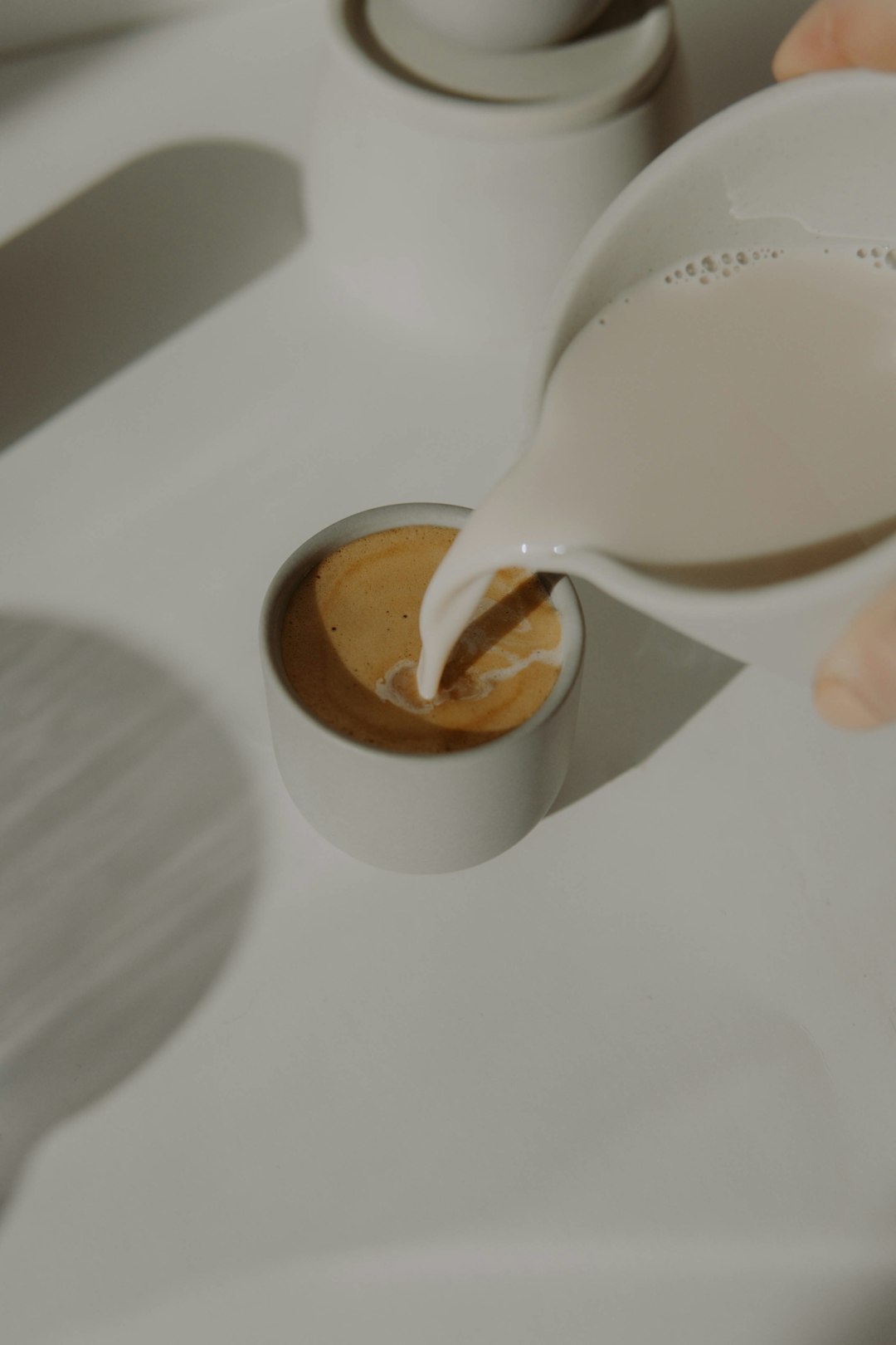 white plastic pitcher on white table