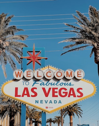 A friendly real estate agent handing over keys to happy new homeowners in front of a Las Vegas property.