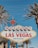 A retro-style welcome sign with the text 'Welcome to Fabulous Las Vegas, Nevada' is surrounded by tall palm trees against a clear blue sky.