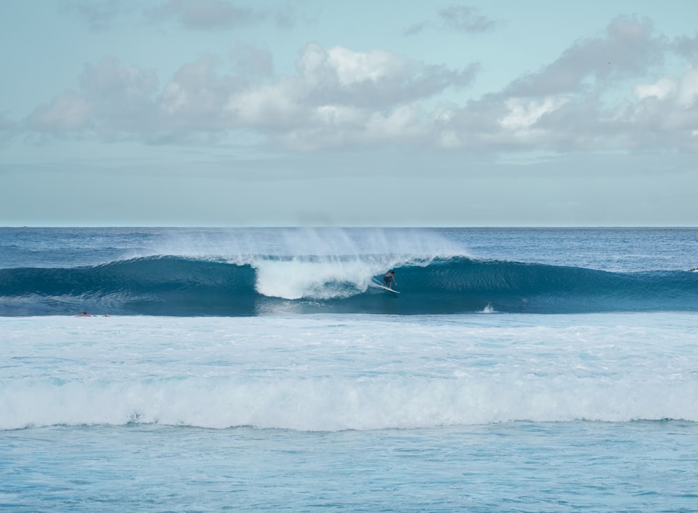 ocean waves under white clouds during daytime