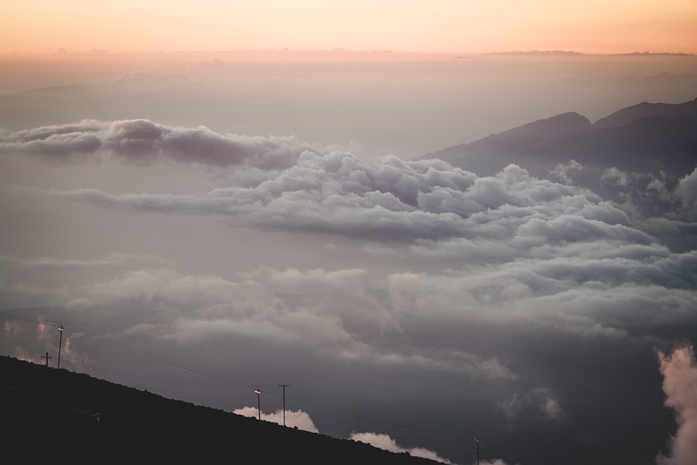 white clouds over mountains during daytime