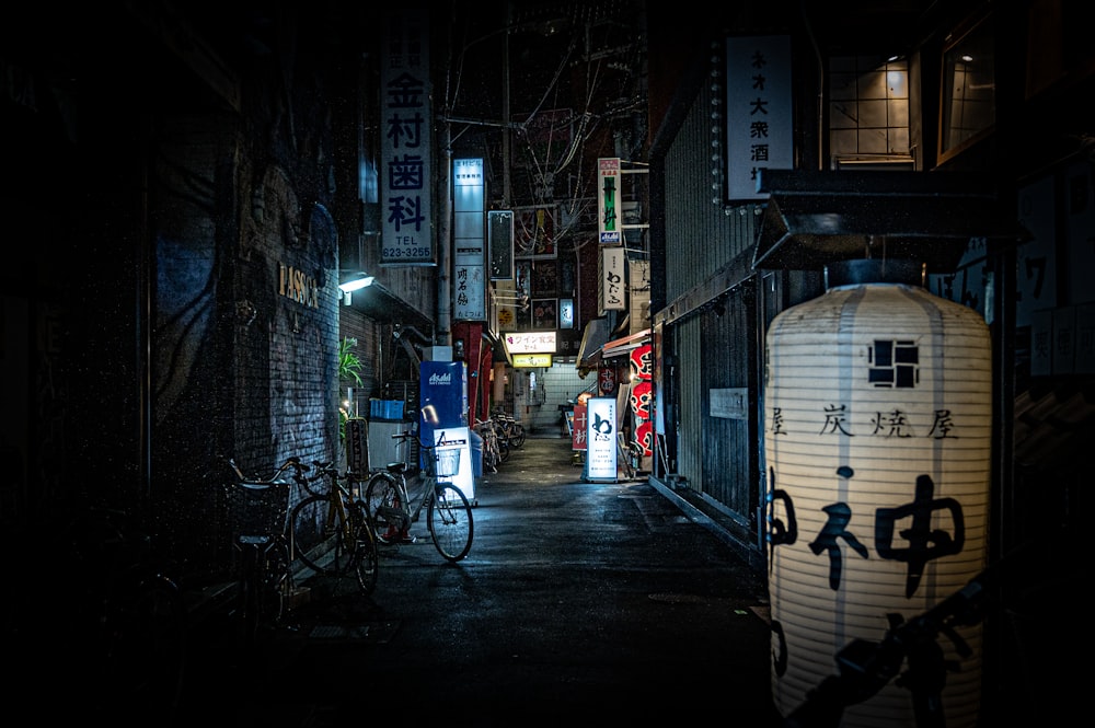 black bicycle parked beside building during night time