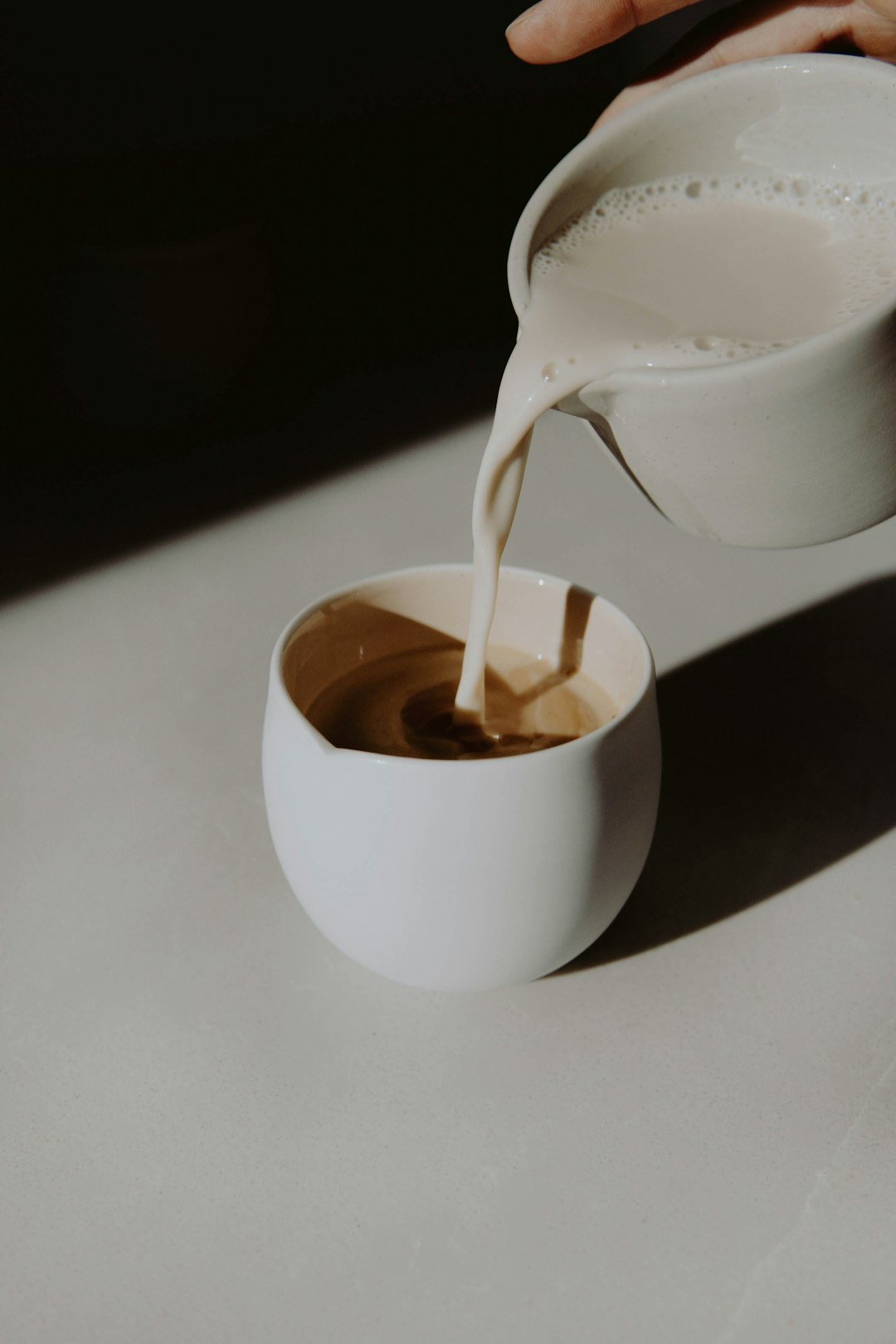 white ceramic mug with brown liquid