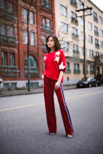 A happy customer wearing a Stellarattire outfit, smiling confidently on a city street.