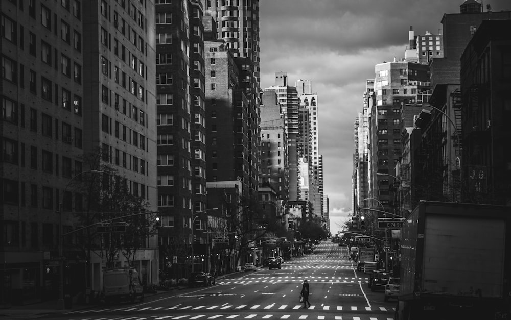 grayscale photo of people walking on pedestrian lane