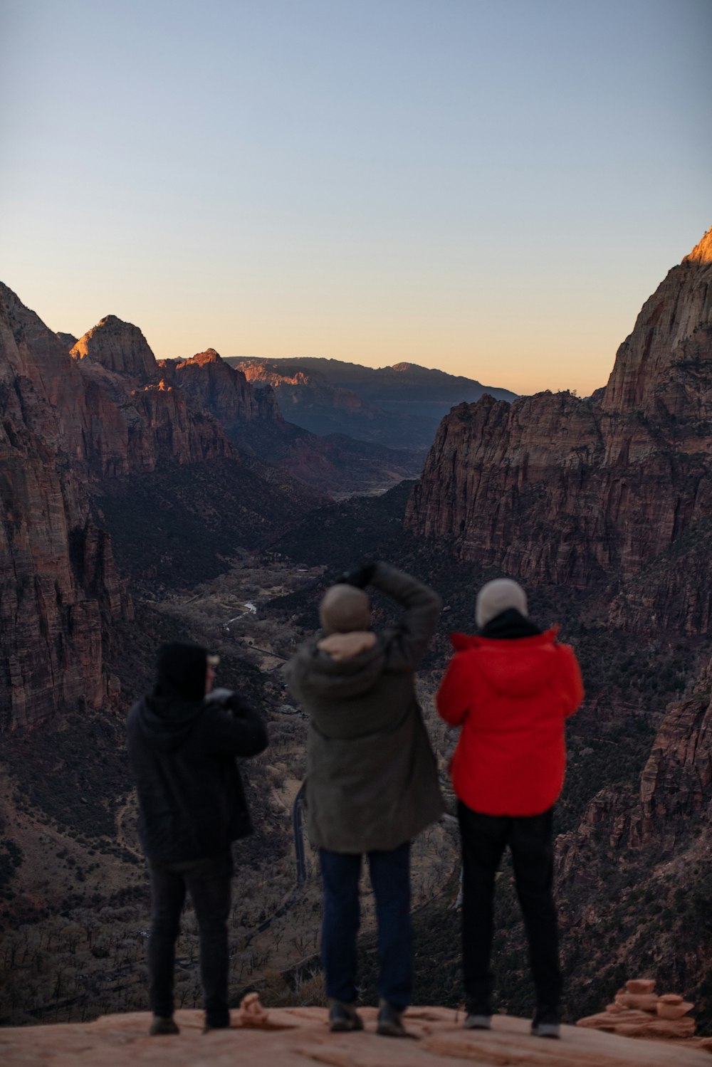 2 person standing on rock formation during daytime