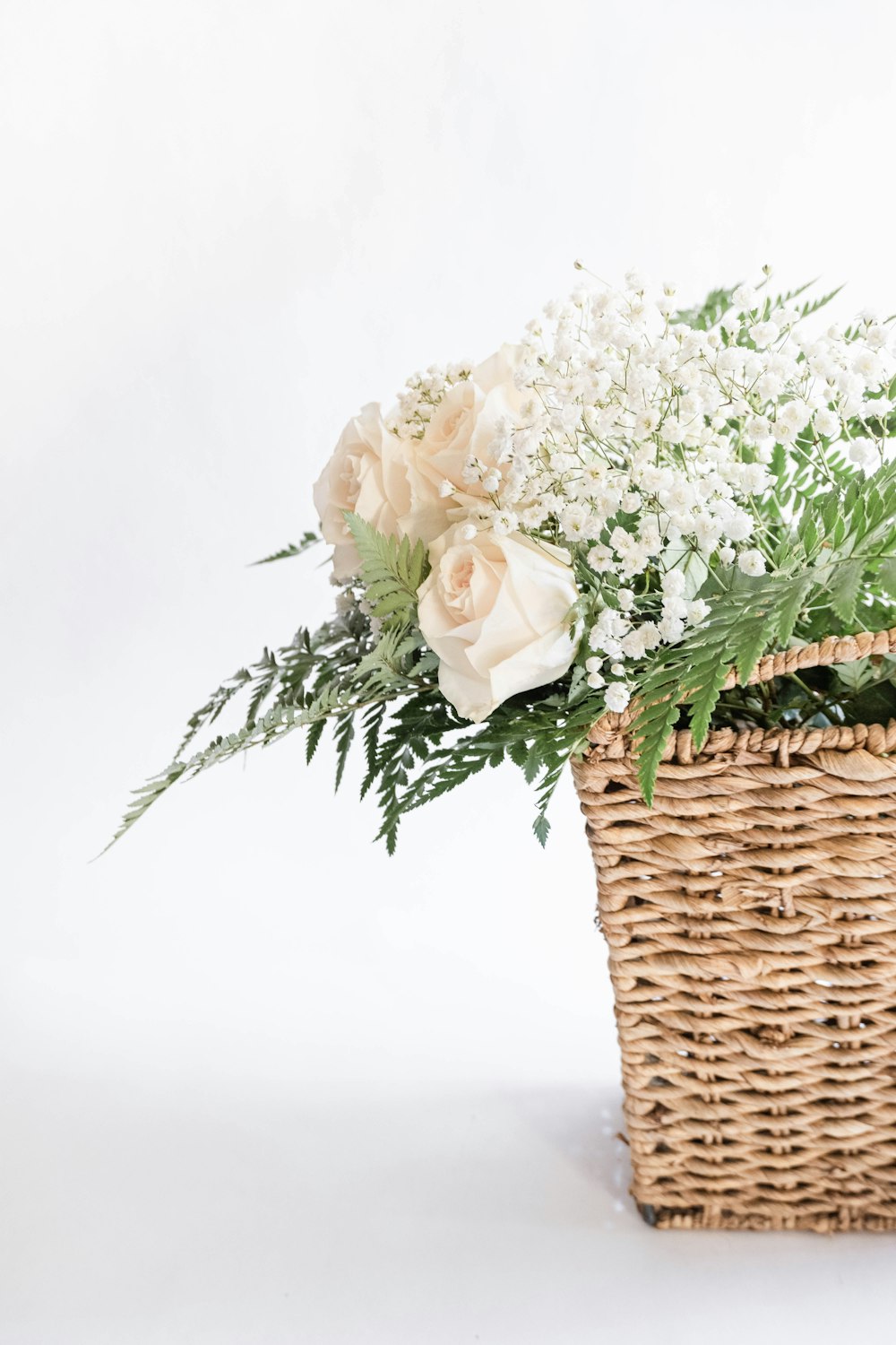 white flowers on brown woven basket