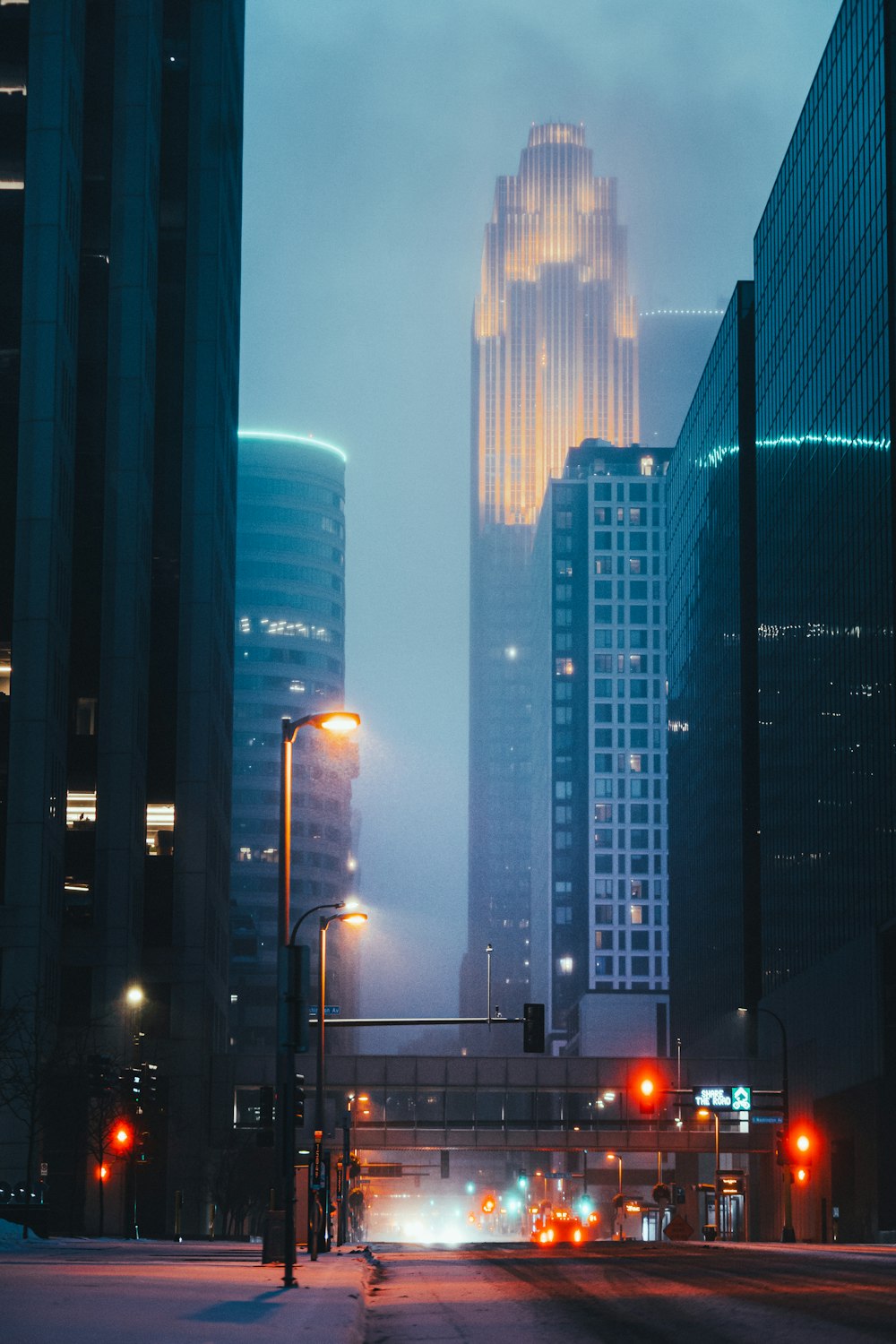 cars on road near high rise buildings during night time