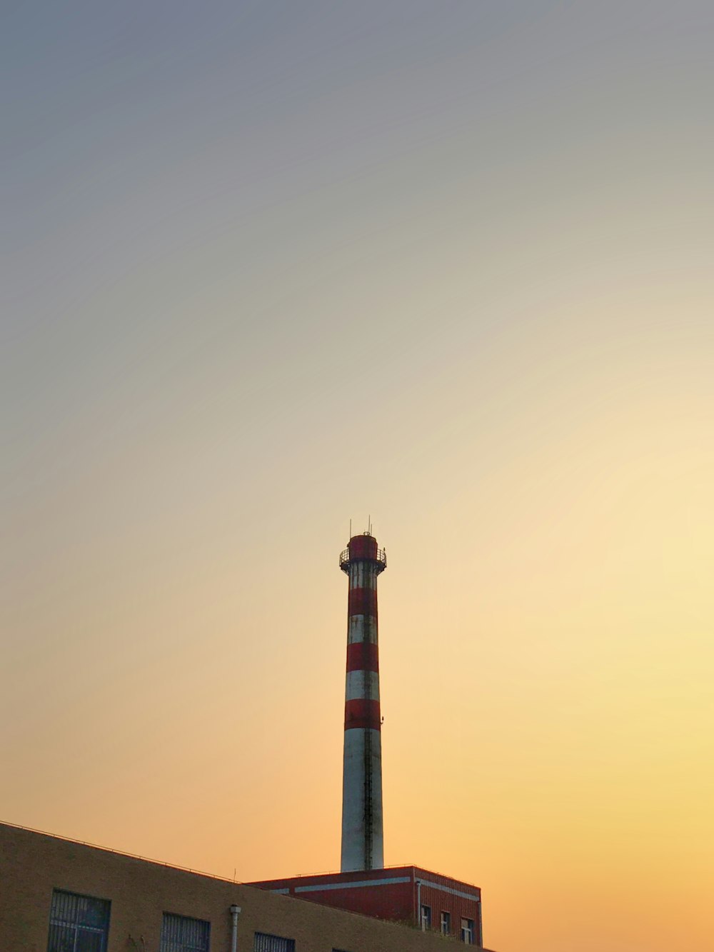 black and white tower during sunset