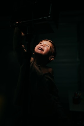 A joyful child on stage during a school play, captured mid-performance with vibrant lighting.