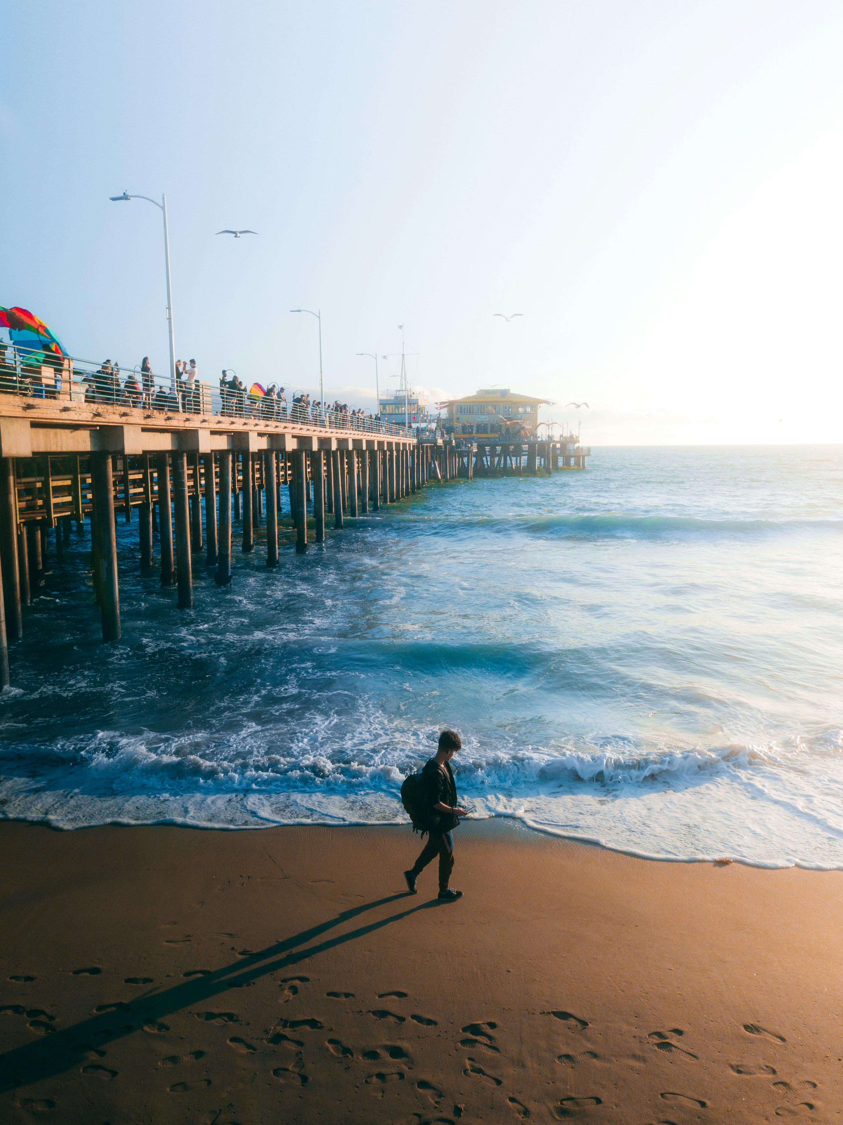 person walking on beach during daytime