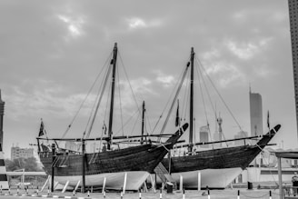 grayscale photo of boat on dock