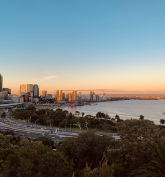 city skyline near sea during sunset