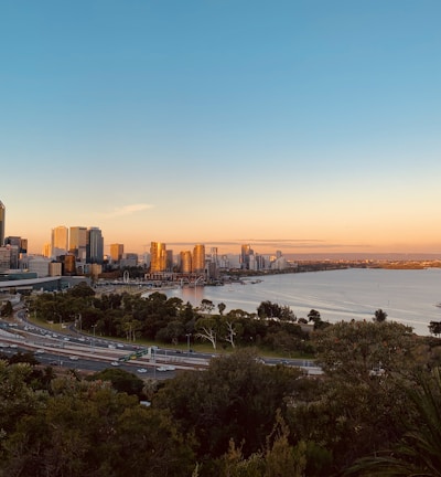 city skyline near sea during sunset