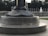 A monument with engravings featuring emblems of the Navy and Army Air Forces, including an inscription that reads 'AMERICANS CAME TO LIBERATE'. The setting appears to be an outdoor memorial area with stone structures and a visible fountain in the background.