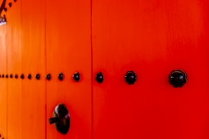 A vibrant red door with classic paneling, welcoming and full of character.