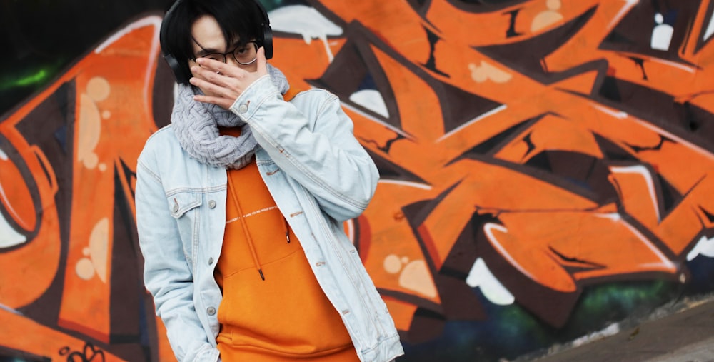 woman in white jacket covering her face with her hand