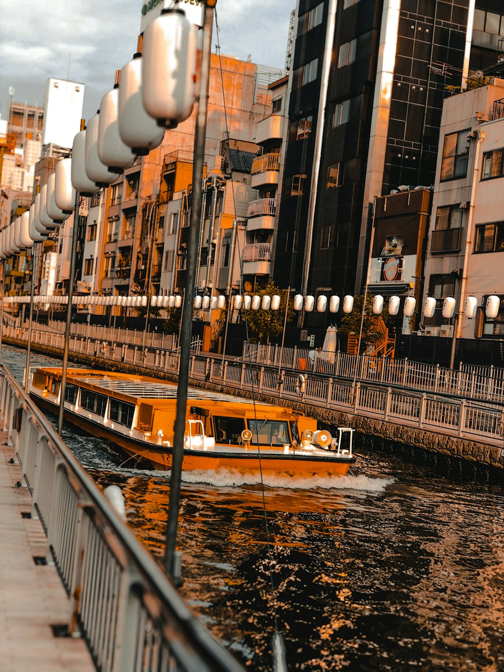 people walking on bridge near buildings during daytime