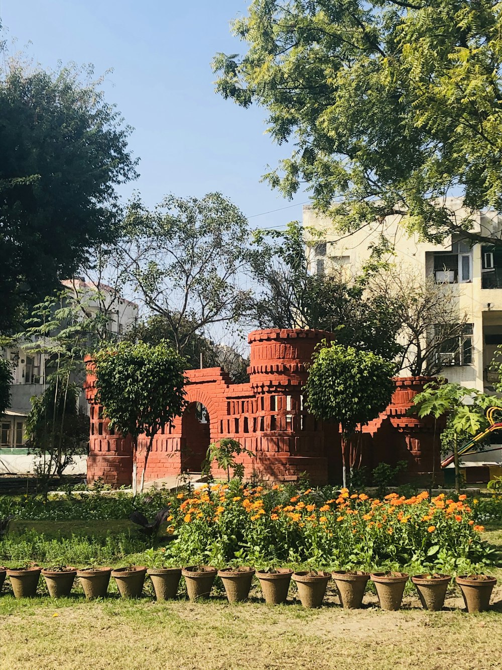 green trees near brown concrete building during daytime