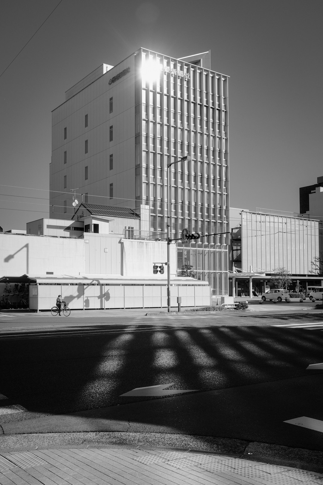 grayscale photo of building with people walking around