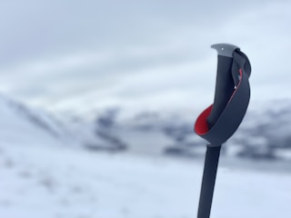 The Ski Watch being attached easily to a hiking pole in a forest setting.