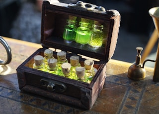 clear glass bottles in brown wooden box