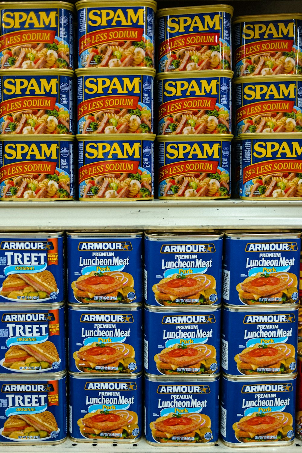 cans of spam are stacked on a shelf