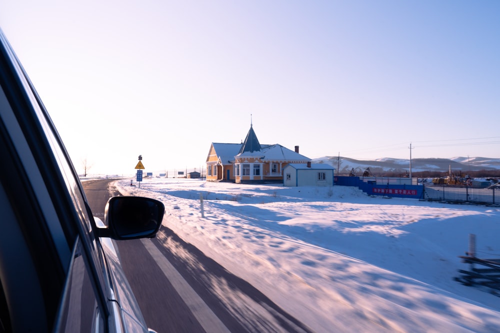 white and brown concrete building near snow covered field during daytime